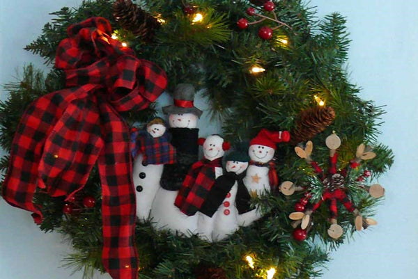 buffalo plaid snowman family in lighted evergreen wreath